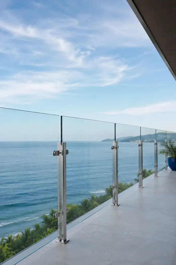 Guarda-corpo de vidro com torres de inox em varanda de frente para o mar